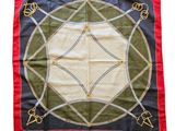 red and green square scarf with a design of flowers and leaves