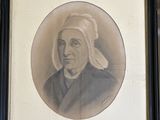 framed portrait of a woman with a turban on her head in a black frame