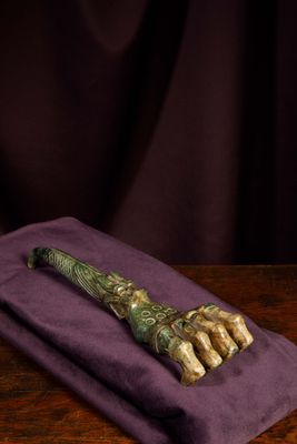 a close up of a knife on a purple cloth on a wooden table