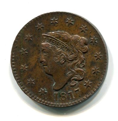 gros plan d'une pièce de monnaie sur laquelle figure une tête de femme