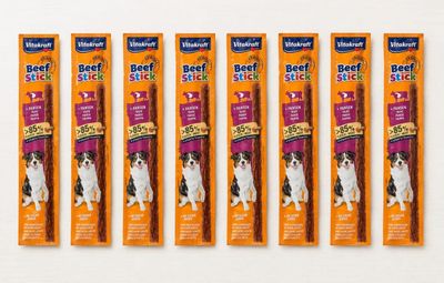 four pack of beef sticks for dogs on a white surface