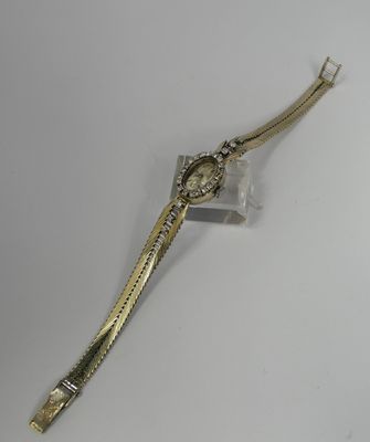 an image of a gold wrist watch on a white surface