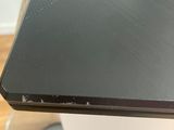 a black laptop sitting on top of a wooden table