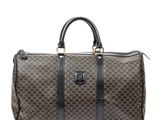 a brown and black duffel bag sitting on top of a white surface