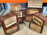 four old fashioned radio ' s stacked on top of each other
