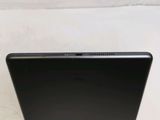 the back of a black laptop computer sitting on top of a white surface