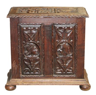 an old wooden chest with carvings on the sides of it
