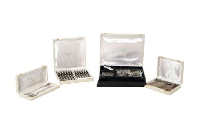 three open silverware boxes with silverware in them on a white surface