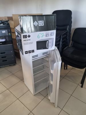 a refrigerator that is sitting in the middle of a room