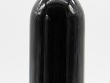 bottle of black wine with a red cap on a white background