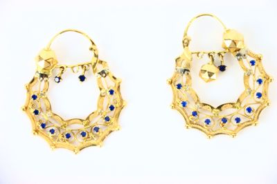 pair of blue and gold hoop earrings on a white background