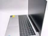a laptop computer sitting on a white surface