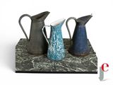 three vases that are sitting on top of a table