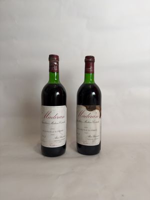 two bottles of wine sitting next to each other on a table
