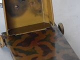 a small metal box with a camouflage pattern on it