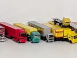 a lot of toy trains that are lined up on the table