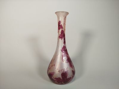 a glass vase with a red and white design on it