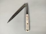 a knife that is laying next to a knife holder