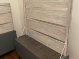 a bed with a wooden headboard on it in a room