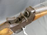 a close up of a wooden rifle with a metal clamp