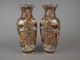 two vases sitting side by side on a gray surface