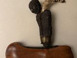 a wooden object with a statue on top of it
