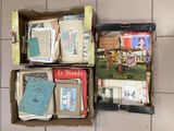several boxes of books are sitting on the floor next to each other