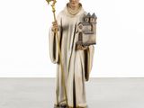 a statue of a man holding a book and a staff