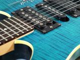 a close up of a guitar with a blue body