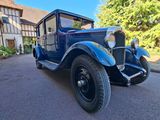 an old blue truck parked in front of a house
