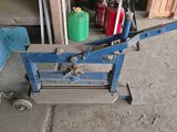a blue machine that is sitting on the floor in a garage