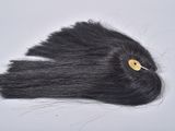 a black hair with a yellow button on top of it