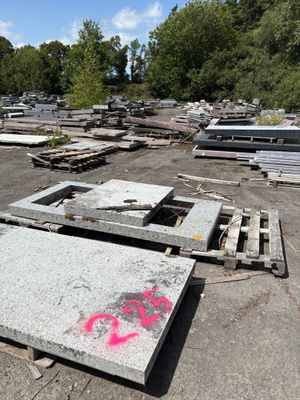 a lot of concrete blocks and pallets on the ground