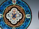 two decorative plates with designs on them on a table