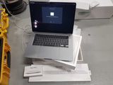 a laptop computer sitting on top of a pile of papers