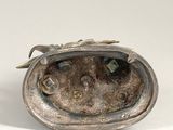 silver plated figurine of a frog with a leaf on its head