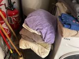 a stack of clothes sitting on top of a washing machine
