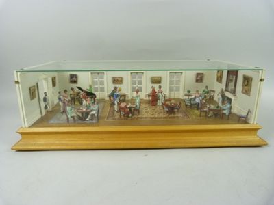 une maquette d'un salon avec des personnages à l'intérieur