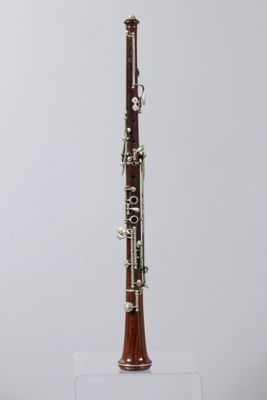 a close up of a clarinet on a white surface