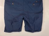 a close up of a pair of blue shorts hanging on a wall