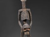 une statue représentant un squelette tenant une tête humaine