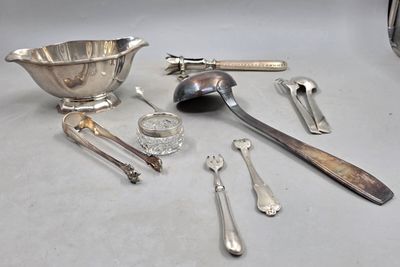 a lot of silver spoons and utensils on the table