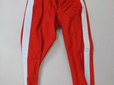 a pair of red and white pants hanging on a wall