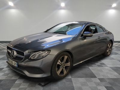 mercedes s - class coupe in a showroom with a checkered floor