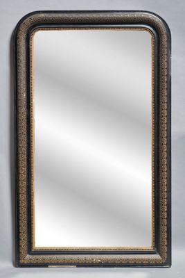un miroir au cadre noir et doré accroché à un mur blanc