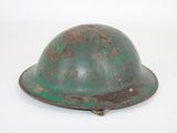 an old helmet is sitting on a white surface with a white background