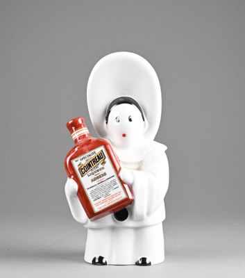 a figurine of a woman holding a bottle of ketchup