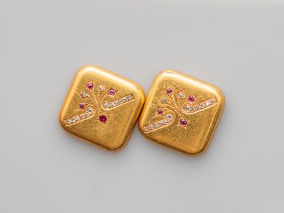a pair of gold and ruby earrings