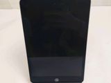 an image of a black tablet computer sitting on top of a white table