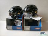 pair of helmets sitting on top of boxes on a white surface
